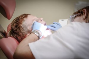 Dentist looking at patient