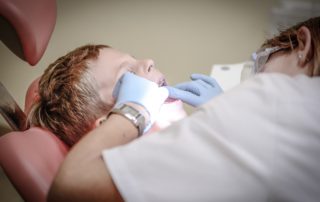 Dentist looking at patient
